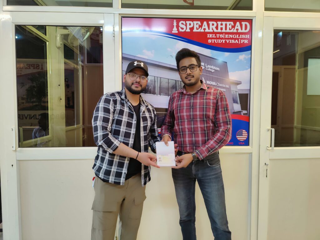 Visa handover moment with a client and study-abroad advisor