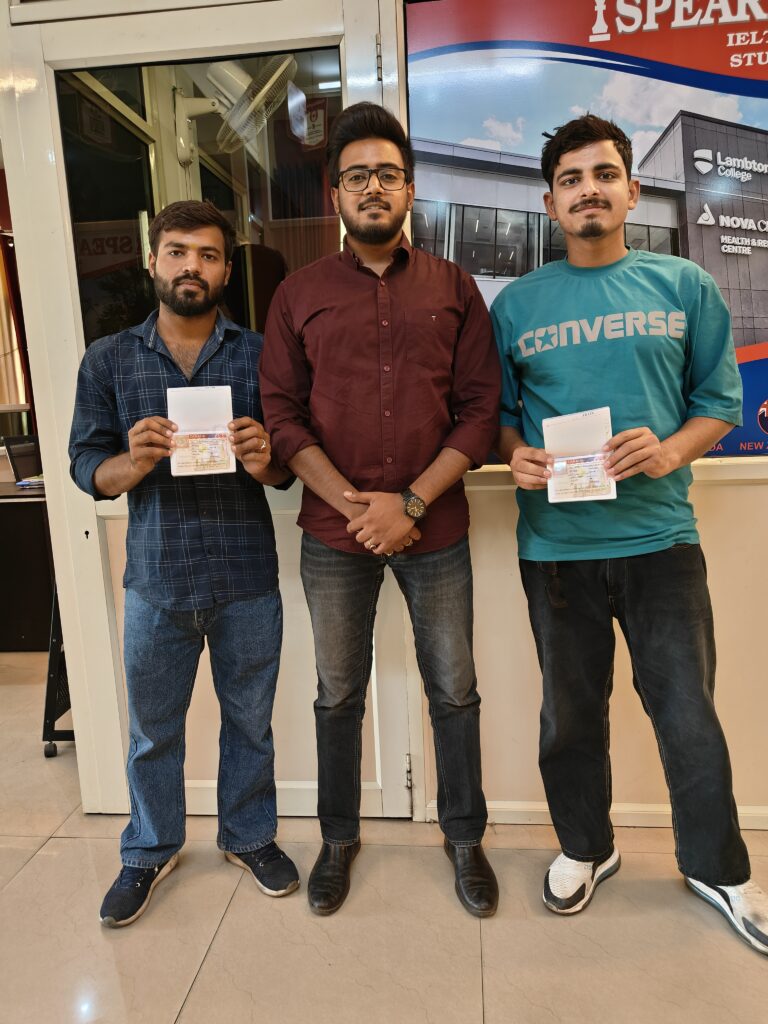 Two clients holding their approved visas after application support